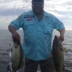 Two fishing rods with reels on beach in FL