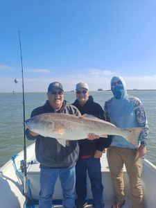 Two anglers hold a big fish in TX