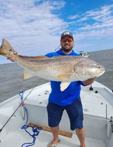 A fisherman successfully catches a 38-inch fish in Port O'Connor