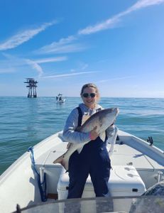 Fisherman holding a 13-inch fish in TX