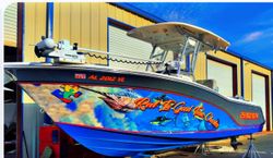 Fishing boat with custom marine artwork displayed at Orange Beach AL