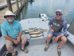 Angler holding a 9-inch redfish in Matagorda