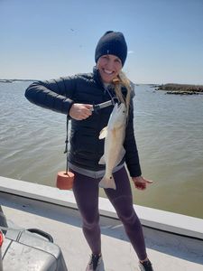 A fisherman with a 15-inch redfish caught in Matagorda