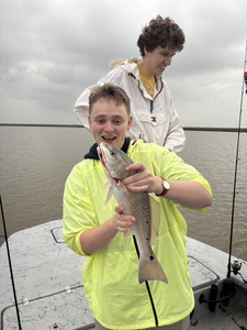 Reeling in a good time by the water.