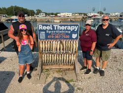 Charter fishing trip display showing multiple caught fish on wooden rack at Oregon OH marina