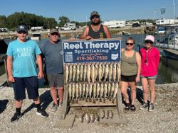 Fishing charter display board showing large catch of fish at Oregon OH marina dock