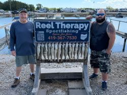Fresh caught walleye displayed on fishing charter sign at Oregon OH marina