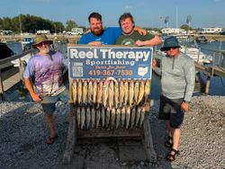 Successful walleye fishing trip in Oregon OH with large catch displayed on cleaning station