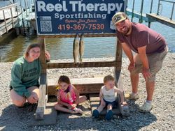Two walleye fish displayed on wooden cleaning station at Oregon OH fishing charter