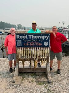 Fresh walleye catch displayed on wooden rack at Oregon OH fishing charter