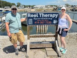 Five walleye displayed on fishing charter sign at Oregon OH marina
