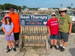 Successful walleye fishing charter display with multiple caught fish at Oregon OH marina