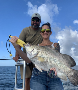 Two people fishing in Apalachicola, with a 28-inch fish caught