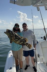 A pair of anglers fishing for a gag grouper in Florida