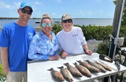 Three people fishing with four fish caught in Florida