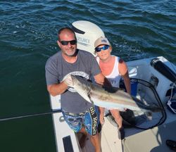 A couple fishing with a large fish in Oxford