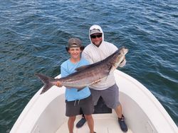 Two anglers holding a freshly caught fish in Oxford