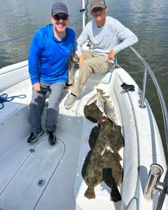 Successful fishing trip in Port Orange FL with Summer Flounder and Southern Flounder catch displayed on boat deck