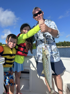 Reeling in a huge Spanish Mackerel under clear skies in Port Orange!
