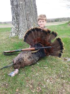 Big wild turkey harvest with youth hunter and shotgun