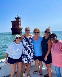 Group of 5 people enjoying fishing trip on Gwynn Island