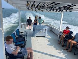 Group of 5 people enjoying a fishing trip on Gwynn Island