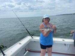 A lone angler fishing on the shores of Gwynn Island