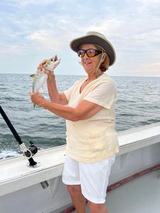 A fisherman holding a Spanish Mackerel fish on Gwynn Island