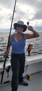 Angler holding a 7-inch fish while fishing in VA