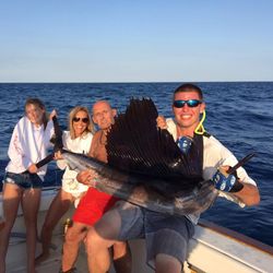 A group of four people fishing for an Atlantic Sailfish in Punta Gorda