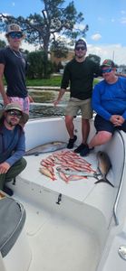 Four people enjoy a fishing trip in Panama City