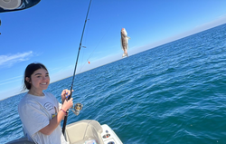 A fisherman holding a 7-inch fish in FL