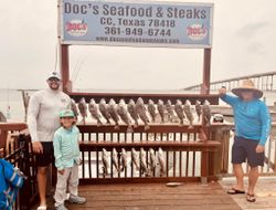 Three people enjoying a fishing tour in Corpus Christi