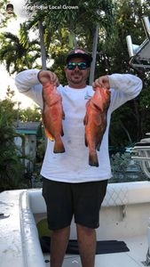 Two anglers fishing in FL with 2 big fish