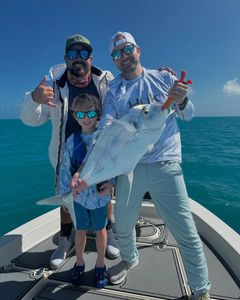 An angler with a 17-inch fish in the waters of Key Largo