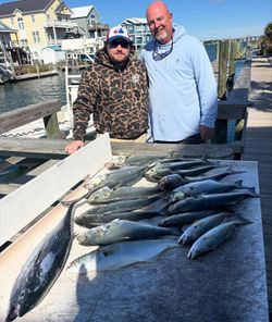 Two people fishing with four fish caught in North Carolina
