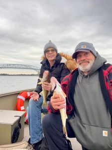 Angler holding a 9-inch walleye in MI