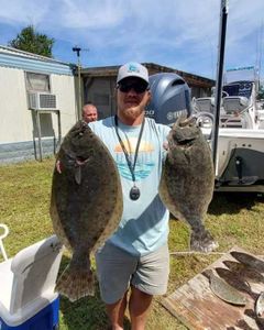Two anglers fishing at Manns Harbor