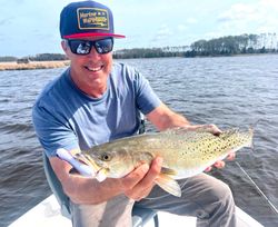 A single fisherman catching a 17-inch fish in North Carolina