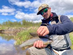 Fisherman catching an Arctic Grayling in St. Joseph