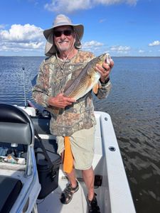 Photograph of a person fishing for a redfish in Lafitte