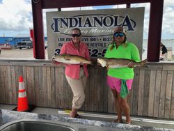 Two anglers fishing in TX with 2 big fish