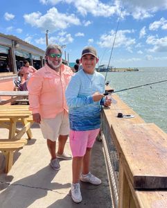 A group of 3 people fishing in TX