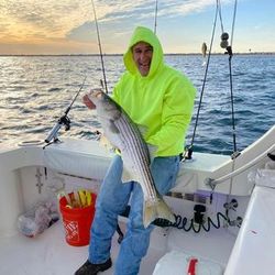 A lone fisherman reeling in a big catch in NJ