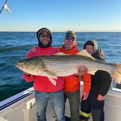 A group of 3 people fishing in the waters of Neptune