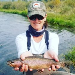 Angler catching a beautiful rainbow trout in California
