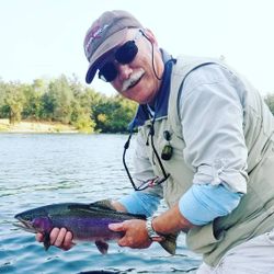 A fisherman with a rainbow trout in Redding