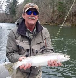 Angler with a beautiful rainbow trout in Redding