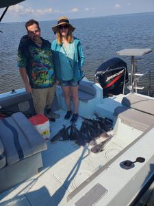 Two people enjoying a fishing tour in FL