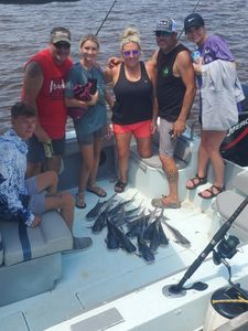 Smiling group of 6 people on a cruise in Gulf Breeze